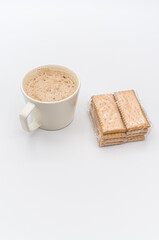 Canvas Print - delicious hot vegan Cappuccino with foam in a white cup and packaged biscuits on a white background