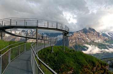 Wall Mural - A breathtaking view of the cliff skywalk in First, Grindelwald, opposite the majestic North Face of Eiger and with a panorama of alpine mountains in Berner Oberland ( Bernese Highland ), Switzerland