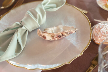 Wall Mural - Wedding table setting in a nautical style. A shell and a napkin in the guests' plate.