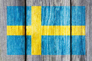 Poster - Grunge pattern of Sweden national flag isolated on weathered wooden fence board.