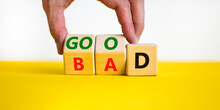 Good Or Bad Symbol. Businessman Turns Wooden Cubes And Changes The Word Bad To Good. Beautiful Yellow Table, White Background, Copy Space. Business And Bad Or Good Concept.
