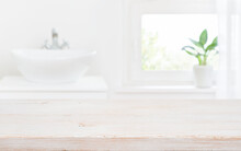 Old Wooden Tabletop On Blur Bathroom Sink And Window Background