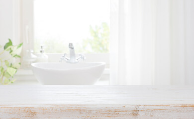 Wall Mural - wooden table top on blurred bathroom sink and curtained window