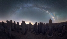 Panorama Of Megalithic Monuments Under Stars Sky With Milky Way Arch
