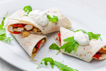 tortilla filled with chicken meat, red pepper and beans