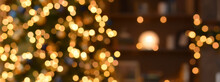 Blurred Christmas Background With Golden Bokeh On Blurred Interior Background.Banner
