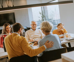 Wall Mural - Happy family having a dinner with red wine at home