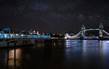 Fototapeta Londyn - Iconic Tower Bridge view connecting London with Southwark over Thames River, UK. Beautiful view of the illuminated bridge at night.
