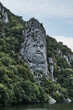 Vertical shot of the Rock Sculpture of Decebalus under a cloudy sky in Romani