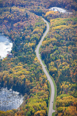 Wall Mural - aerial view of curving road and lakes and trees in northern minnesota on a sunny autumn day