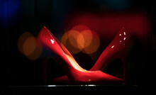 Luxury Lifestyle Clothes. An Amazing Pair Of Elegant Lady Red Shows In A Store Window With Great Reflections.
