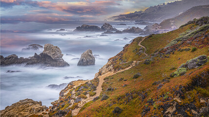 Wall Mural - Beautiful view of a landscape with a sea and large rocks under the clear sky