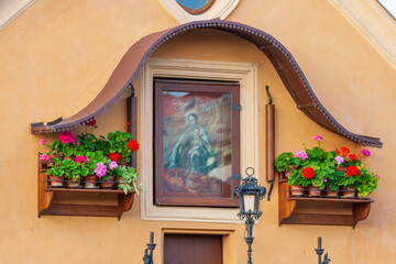 Wall Mural - Small painted shrine on building next to the Charles Bridge in Prague, UNESCO World Heritage Site, Czech Republic.