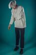© qunica.com - Male beauty concept. Portrait of fashionable young man with stylish haircut wearing trendy glasses and sweater, posing over gray background. Perfect hair & skin. Hipster style. Copy-space. Studio shot