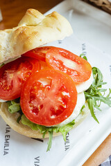 Poster - Vertical shot of an egg sandwich with some tomatoes on top