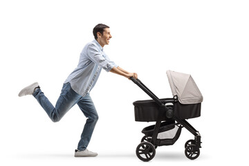 Sticker - Full length profile shot of a cheerful father running and pushing a stroller