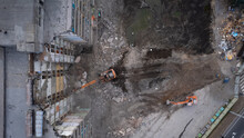 Excavator For Dismantling Buildings, Using A Special Claw, Dismantles A Multi-storey Building. View From Above