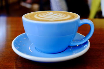 Sticker - Closeup shot of cappuccino in a blue cup