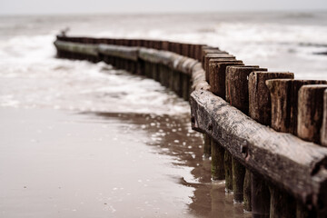 Canvas Print - Closeup shot of the breakwater structure in a calm sea