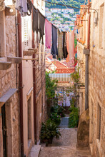 Dubrovnik, Croatia. Looking Down A Steep And Narrow Passage Between Buildings, With Laundry Strung Across.