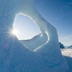 Wall Mural - Iceberg frozen into the sea ice of the Uummannaq fjord system during winter. Greenland, Danish Territory