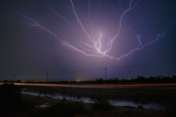 Wall Mural - beautiful scene of a lightning in the sky over the highway