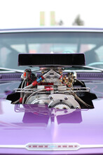 Vertical Shot Of A Custom Classic Purple Muscle Car With A Customized Engine