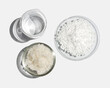 © chadchai - Carbamide in Chemical Watch Glass place next to flake salt and beaker. Closeup chemical ingredient on white laboratory table. Top View