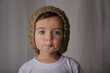 portrait of a little boy wearing a hat knitted by grandmother