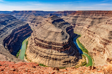 Poster - monument valley, utah. san juan river running through three sinuous canyons and valleys.