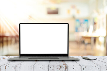 Notebook computer on the table with blank screen on classroom background
