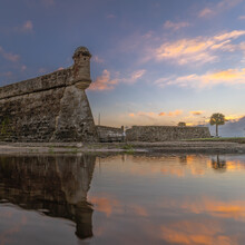 Castillo De San Marcos Masonry Fort Reflecting In Clear Water During The Sunset