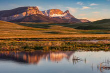 Sawtooth Ridge Reflects Into Wetlands Along The Rocky Mountain Front Near Augusta, Montana, USA