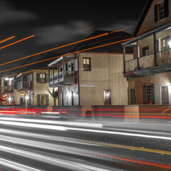 Sticker - Closeup shot of illuminated town and long exposure car lights on the roads in the evening