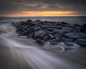 Sticker - USA, New Jersey, Cape May National Seashore. Sunrise on rocky shore and ocean.