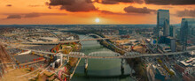 A Gorgeous Aerial Panoramic Shot Of The Green Waters Of The Cumberland River With Bridges Across The River And Autumn Colored Trees With A Vast View Of The Cityscape With Powerful Clouds At Sunset
