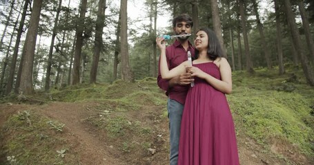 Poster - A Slow-motion of a South Asian romantic couple hugging each other for a photoshoot in the green park