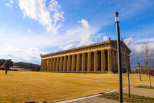 A Full-scale Replica Of The Original Parthenon In Athens With Tall Stone Pillars Around The Building Surrounded By A Gorgeous Autumn Landscape With Blue Sky And Clouds At Centennial Park In Nashville