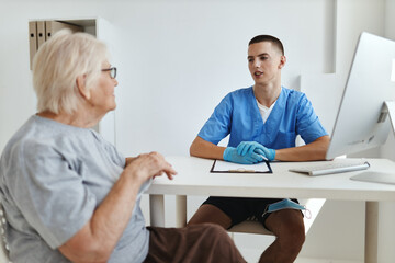 Sticker - elderly woman patient is examined by a doctor professional consultation