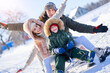 © Kalim - Nice happy family having fun on winter snow