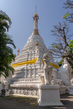 Scenic Low Angle View Of Beautiful Ancient Burmese Style White Stupa Or Chedi With Guardian Lion At Wat Mahawan Buddhist Temple, Chiang Mai, Thailand