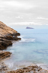 Poster - Scenic view of a rocky beach against a cloudy sky