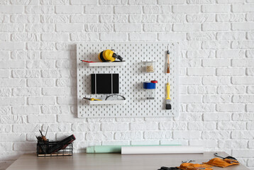 Workplace of engineer with peg board on wall