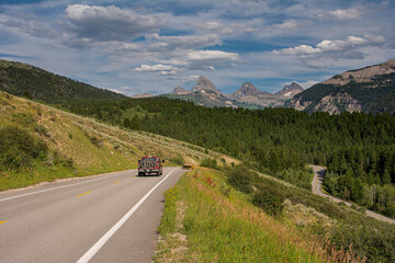 Sticker - USA, Wyoming. Truck with several mountain bikes on Ski Hill Road with view of Grand Teton, west side of Teton Mountains