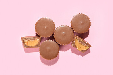 Wall Mural - Tasty peanut butter cups on color background