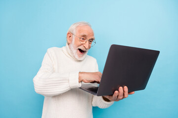 Wall Mural - Photo of hooray elder beard man type laptop wear spectacles sweater isolated on blue color background