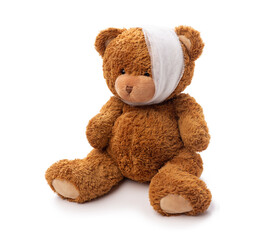 Wall Mural - medicine, healthcare and childhood concept - teddy bear toy with bandaged head having toothache on white background