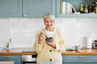© Syda Productions - breakfast, food and people concept - happy smiling woman with spoon eating cereal on kitchen at home