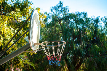 Poster - Basket of basketball of metal in a park with trees, street basketball