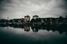 Scenic View Of Residential Buildings Reflected On The Water On A Cloudy Weather